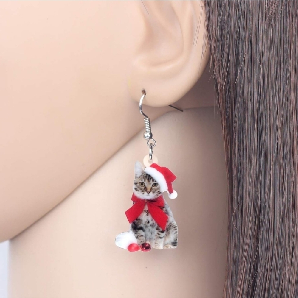 Women's jewelry festive holiday cat in Santa hat with a red bow dangle earrings